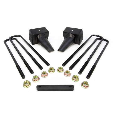 ReadyLIFT Block Kit, full kit on a studio background: two black tapered 4" rear lift blocks with four square U-bolts, gold nuts and a spacer plate on white