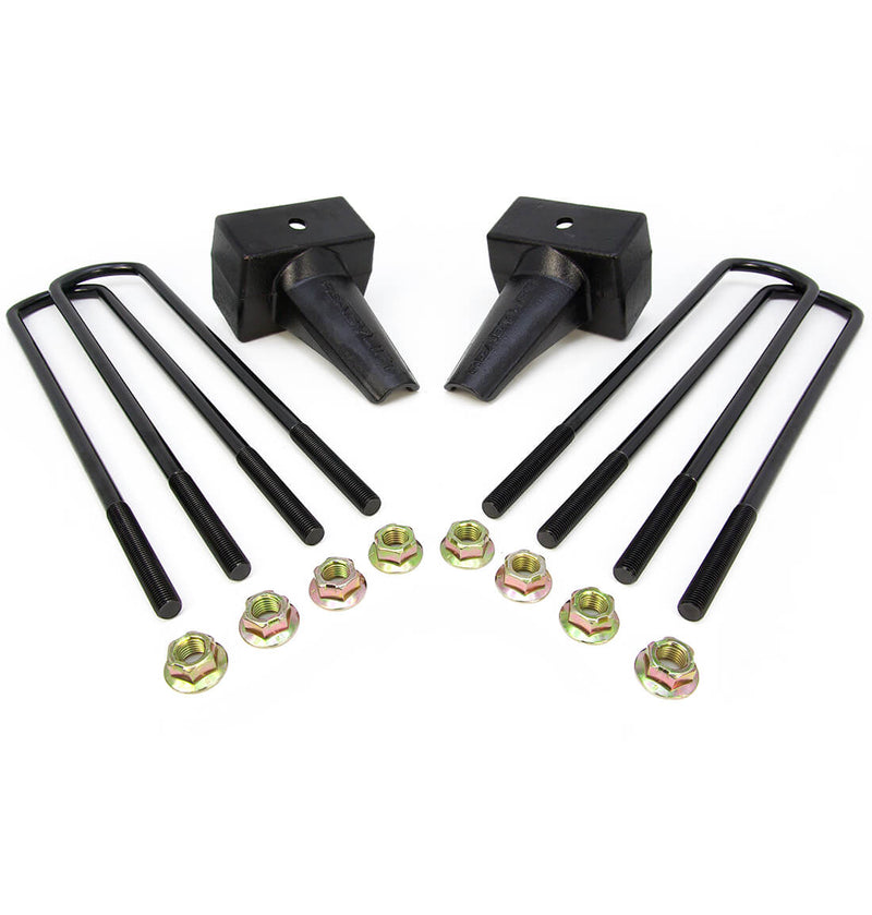ReadyLIFT Block Kit, full kit on a studio background: two black tapered 4" rear lift blocks with four square black U-bolts and gold nuts on white