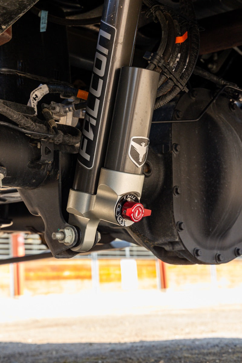 ReadyLIFT Coilover Front Lift Kit on a vehicle: Falcon reservoir shock with red adjuster installed at the rear axle, vertical crop