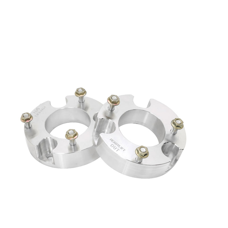 ReadyLIFT Leveling Kit, full kit on a studio background: pair of machined aluminum strut spacers with studs, ReadyLIFT stamped, on white