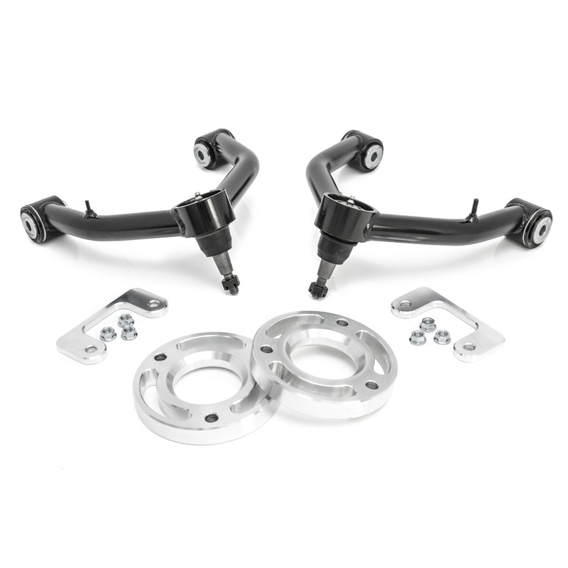 ReadyLIFT Leveling Kit, full kit on a studio background: two black tubular upper control arms with aluminum spacer rings, brackets and nuts on white