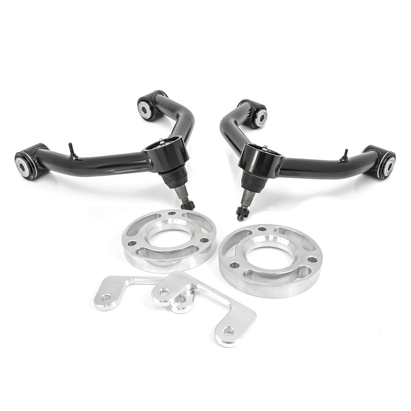 ReadyLIFT Leveling Kit, full kit on a studio background: two black tubular upper control arms with aluminum spacer rings and brackets on white
