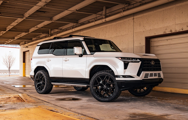 ReadyLIFT Leveling Kit installed on a Lexus GX 550: white Lexus GX 550 on black wheels parked in a covered garage