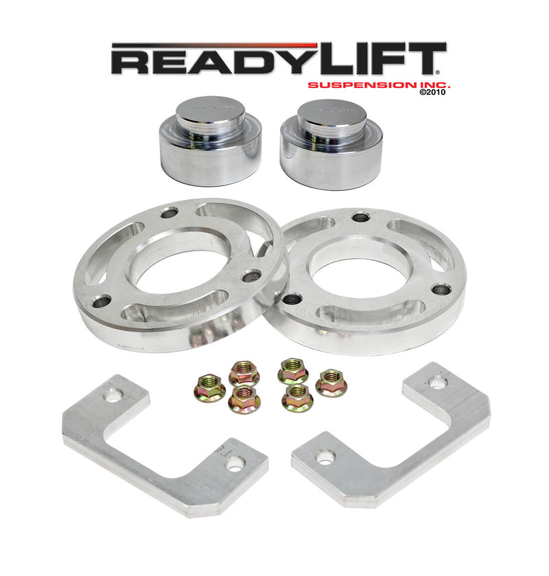 ReadyLIFT SST Lift Kit, full kit on a studio background: aluminum front spacer rings, rear coil spacers, two aluminum brackets and nuts under a ReadyLIFT logo