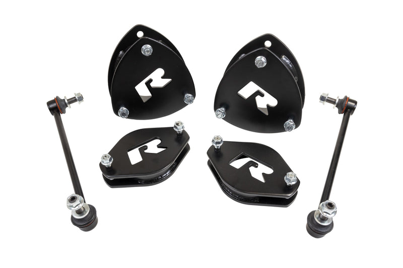 ReadyLIFT SST Lift Kit, full kit on a studio background: four black ReadyLIFT R strut spacers and two sway bar links on white