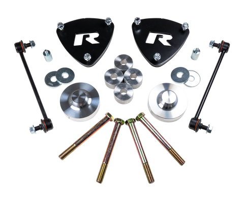 ReadyLIFT SST Lift Kit, full kit on a studio background: two black R strut spacers, aluminum rear spacers, sway bar links and long bolts on a black background
