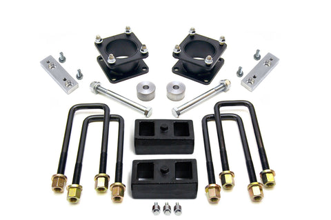 ReadyLIFT SST Lift Kit, full kit on a studio background: two black square strut spacers, aluminum brackets, two rear blocks, U-bolts and bolts on white