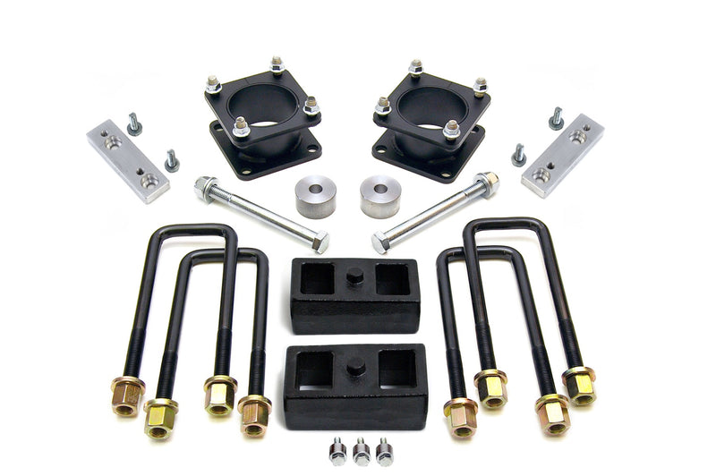 ReadyLIFT SST Lift Kit, full kit on a studio background: two black square strut spacers, aluminum brackets, two rear blocks, U-bolts and bolts on white