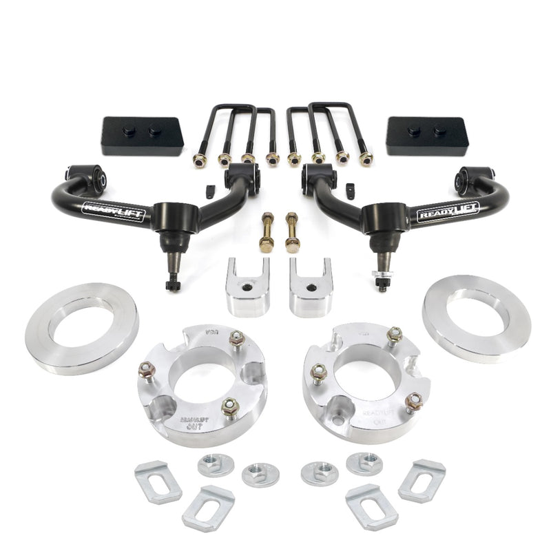 ReadyLIFT SST Lift Kit, full kit on a studio background: two black upper control arms, aluminum strut spacers, flat rear blocks, U-bolts and hardware on white