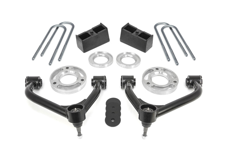 ReadyLIFT SST Lift Kit, full kit on a studio background: two black upper control arms, aluminum strut spacers, rear blocks, zinc U-bolts and bump stop pads on white