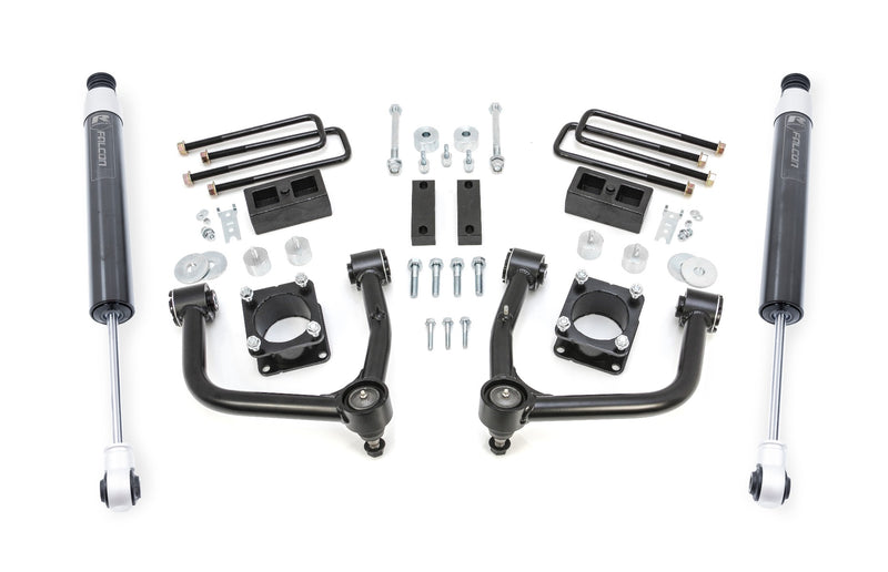 ReadyLIFT SST Lift Kit, full kit on a studio background: two black upper control arms, strut spacers, rear blocks, U-bolts and two gray Falcon rear shocks on white