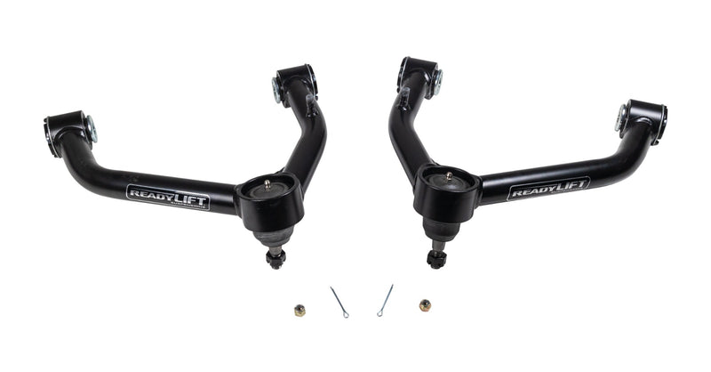 ReadyLIFT SST UCA, full kit on a studio background: A pair of black ReadyLIFT upper control arms with ball joints, nuts and cotter pins on white