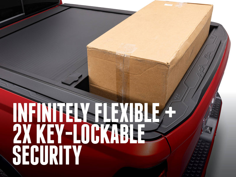 Cardboard box standing in the bed with the ONE MX locked part-open, INFINITELY FLEXIBLE + 2X KEY-LOCKABLE SECURITY caption