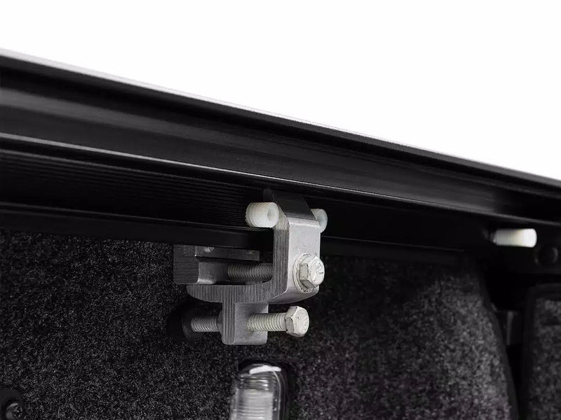 Close-up of the aluminum clamp holding the RetraxONE XR rail to the bed wall