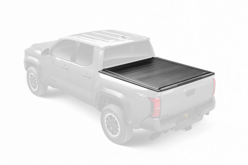 Retrax PowertraxPRO MX cover closed on a ghosted pickup, product shown in full color from a high rear three-quarter angle