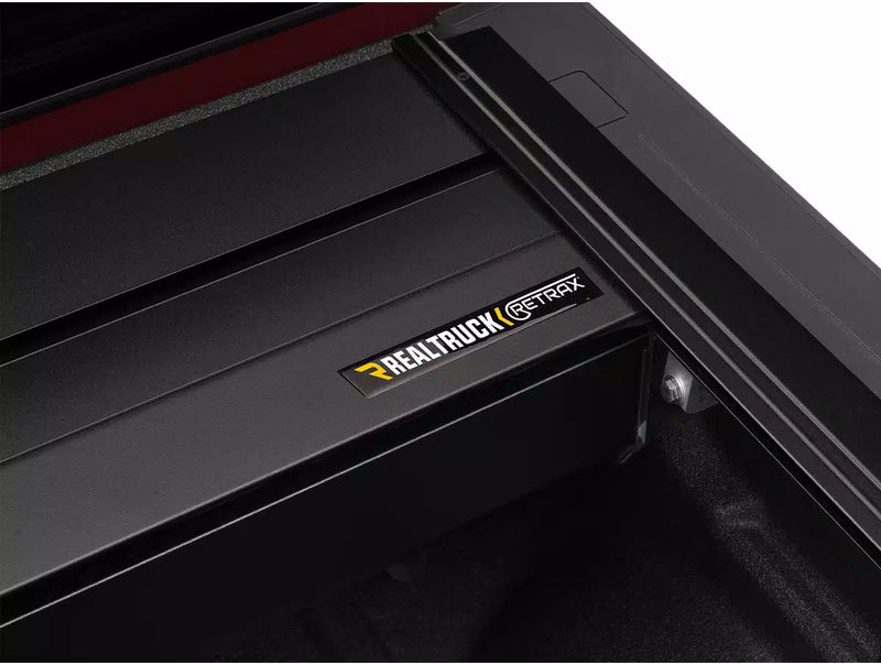 RetraxPRO MX canister lid with the Retrax badge, side rail and clamp at right