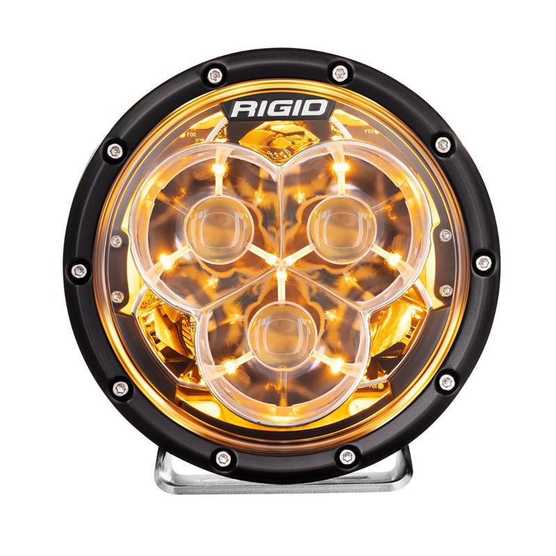 Rigid 360-Series Laser Optic 6" Pair on a studio background: A single 6" round Rigid 360-Series light glowing amber through its three-optic lens on white