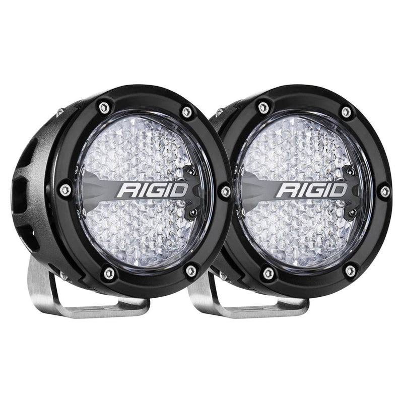 Rigid 360-Series PRO 4" Pair on a studio background: A pair of black 4" round LED lights with diffused flood lenses on polished brackets against white
