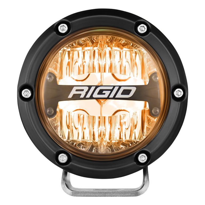 Rigid 360-Series PRO 4" Pair on a studio background: A single 4" round LED light glows with an amber backlight behind its clear optics against white