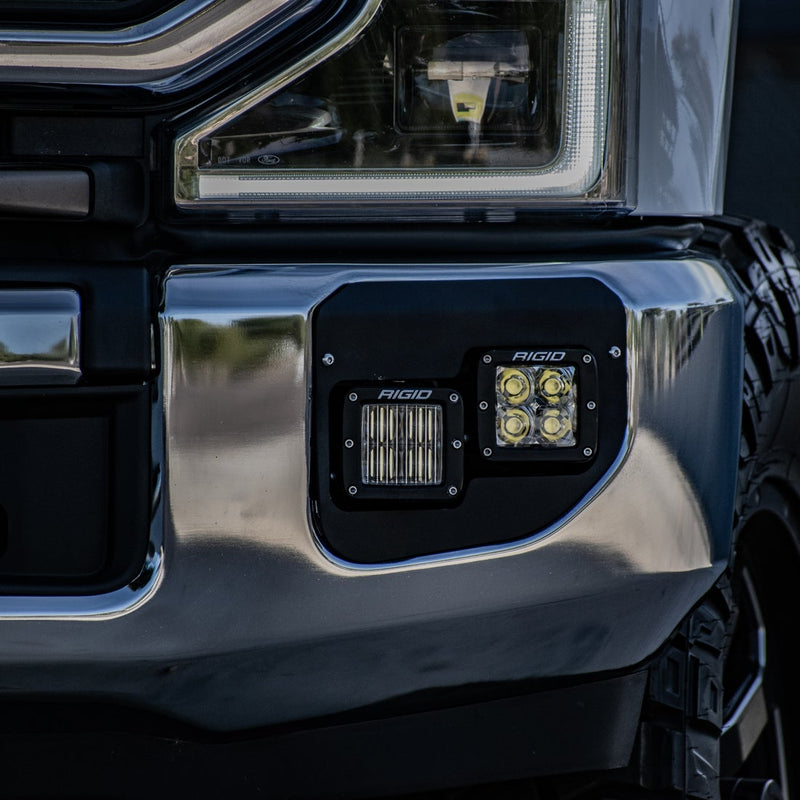 Rigid D-Series Fog Light Kit installed on a vehicle: two Rigid D-Series pods fitted in the fog pocket of a chrome front bumper