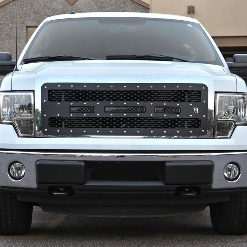 Rigid SR-Series PRO 30" Spot Midnight installed on a Ford F-150: A white Ford F-150 wears a black mesh grille fitted with three small Rigid LED light bars