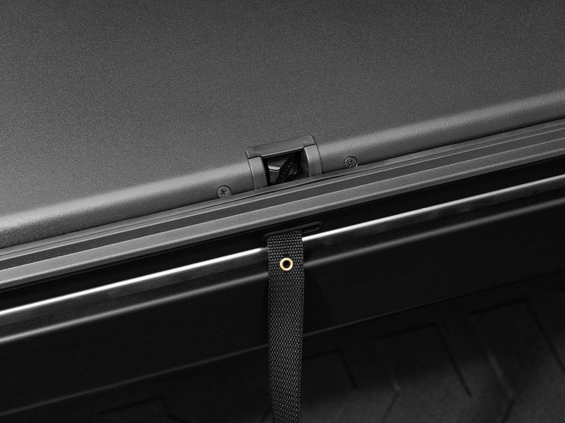 Roll-N-Lock A-Series rail and the webbing pull strap used to close the cover