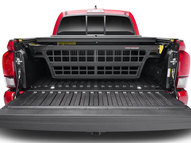 Roll-N-Lock Cargo Manager raised across the bed of a 2016-2023 Toyota Tacoma, straight on from the open tailgate