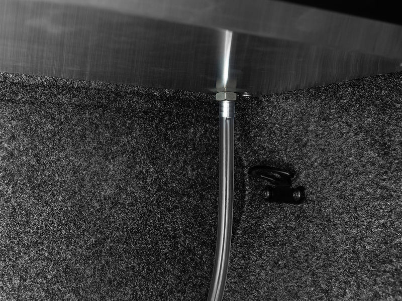 Roll-N-Lock E-Series drain tube running down the inside of the bed corner
