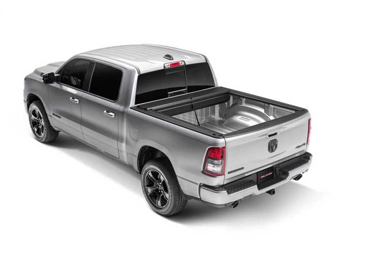 Roll-N-Lock M-Series fully retracted into its canister on a 2019-2026 Ram 1500, open bed
