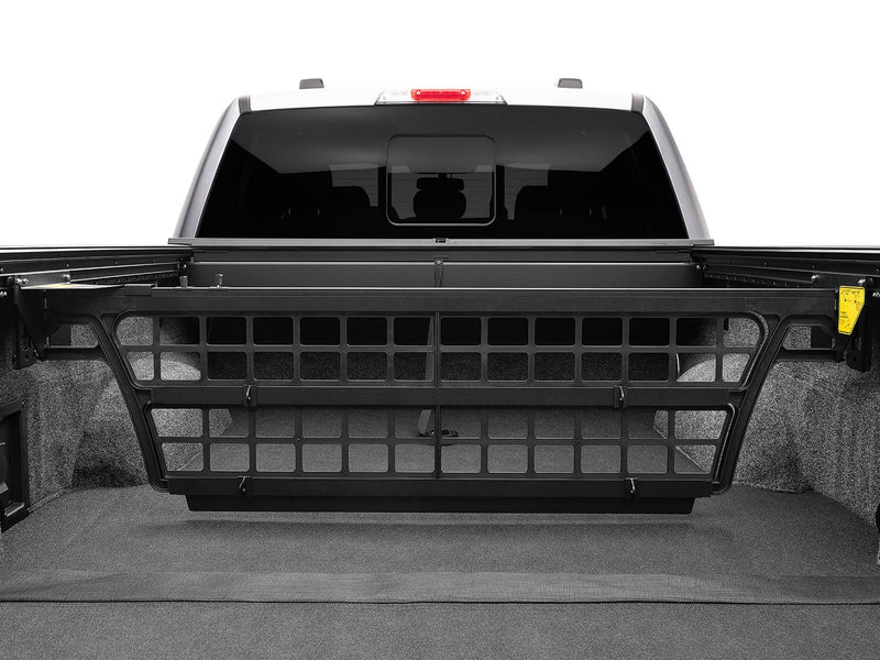 Roll-N-Lock Cargo Manager bed divider raised across the full bed width, straight-on view (tonneau cover sold separately)