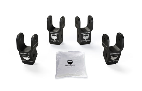 TeraFlex Shock Extension Bracket Kit, shown on a studio background: four black TeraFlex 2" shock extension brackets with part numbers and hardware pack on white
