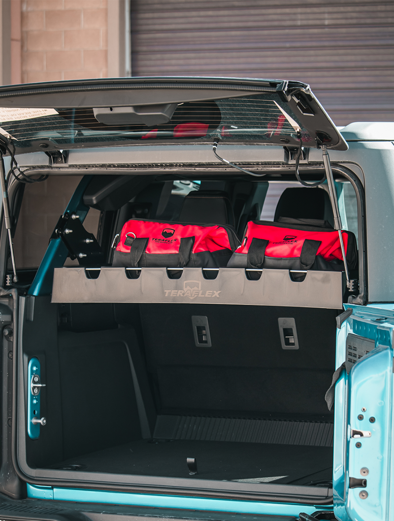 TeraFlex Sierra rear cargo rack holding red bags in the cargo area of a 4-door Ford Bronco