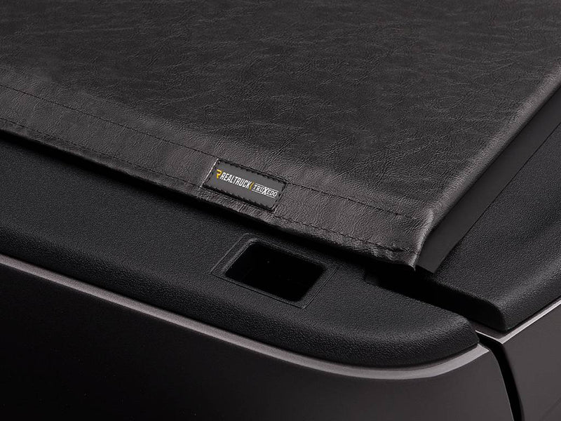 Close-up of the black vinyl cover surface with a small TruXedo label near the corner