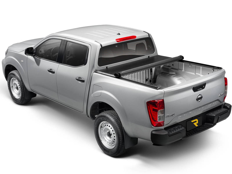 Lo Pro cover rolled up at the front of the bed on a silver pickup, rear three-quarter view