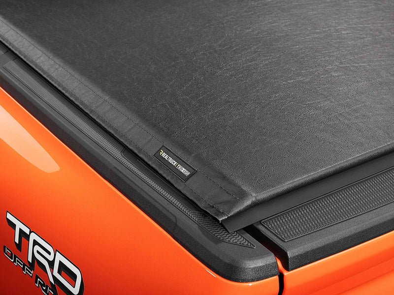 Corner of the closed Lo Pro cover showing the black leather-grain vinyl top and the TruXedo label