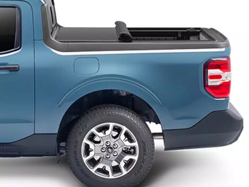 Side profile with the soft cover rolled partway toward the cab