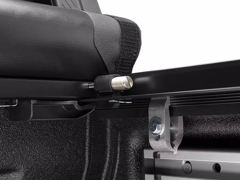 Close-up of the rail clamp and its tightening knob under the rolled cover