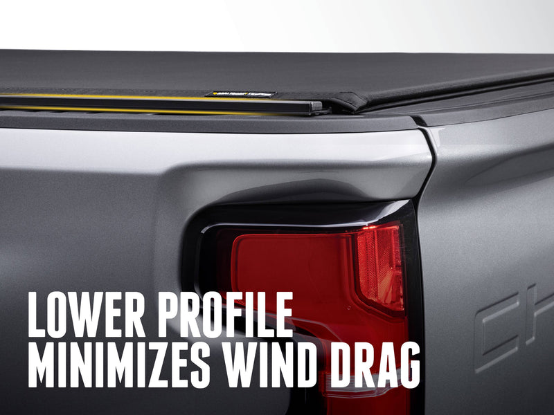 Low-profile side rail and canvas edge above a pickup tail light, with the text Lower profile minimizes wind drag