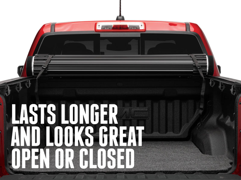 Sentry rolled up and strapped at the cab over an open red pickup bed, with the text Lasts longer and looks great open or closed