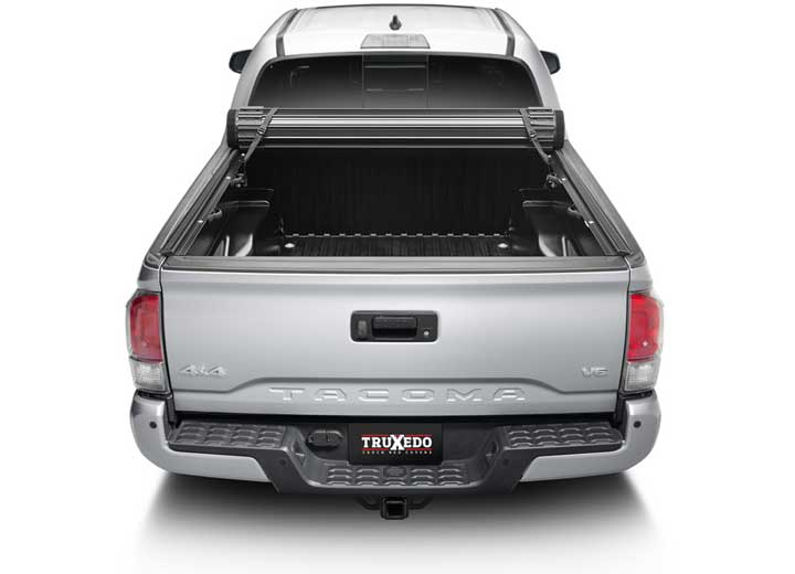 TruXedo Sentry CT hard roll-up tonneau cover rolled partway open on a 2016-2023 Toyota Tacoma, straight rear view