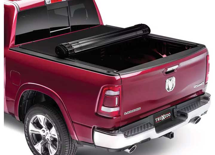 TruXedo Sentry CT hard roll-up tonneau cover rolled forward to the cab on a 2019-2024 Ram 1500, rear three-quarter view