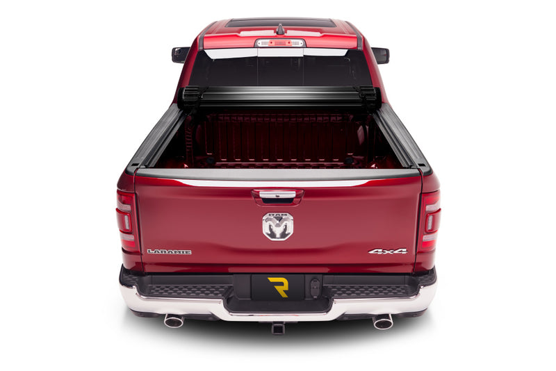 TruXedo Sentry CT hard roll-up tonneau cover rolled forward to the cab on a 2019-2024 Ram 1500, straight rear view