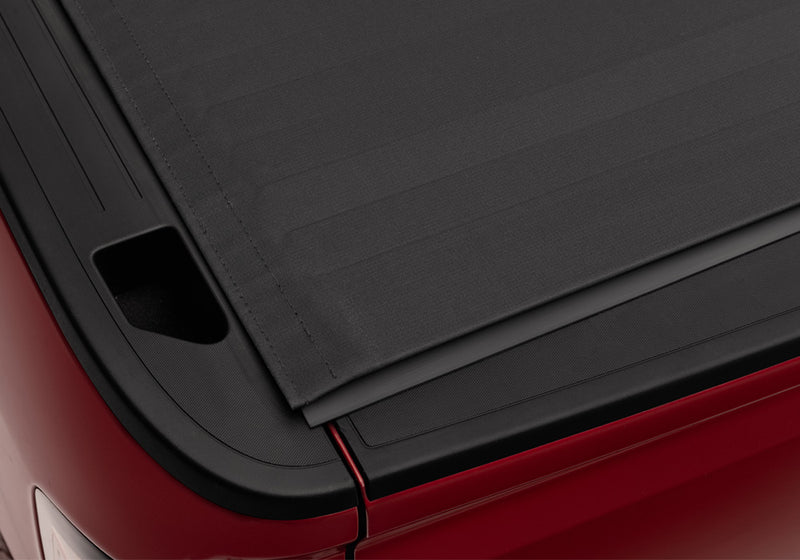 Close-up of the canvas surface at the cover's rear corner, seen from above on a TruXedo Sentry CT hard roll-up tonneau cover