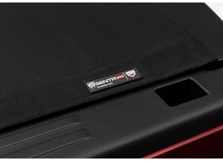 Close-up of the TruXedo name plate on the cover on a TruXedo Sentry CT hard roll-up tonneau cover