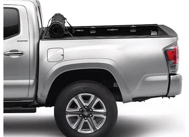 TruXedo Sentry hard roll-up tonneau cover rolled forward to the cab on a 2016-2023 Toyota Tacoma, photographed on location