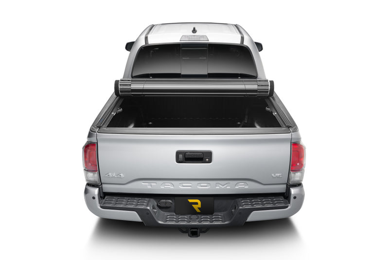 TruXedo Sentry hard roll-up tonneau cover rolled partway open on a 2016-2023 Toyota Tacoma, straight rear view