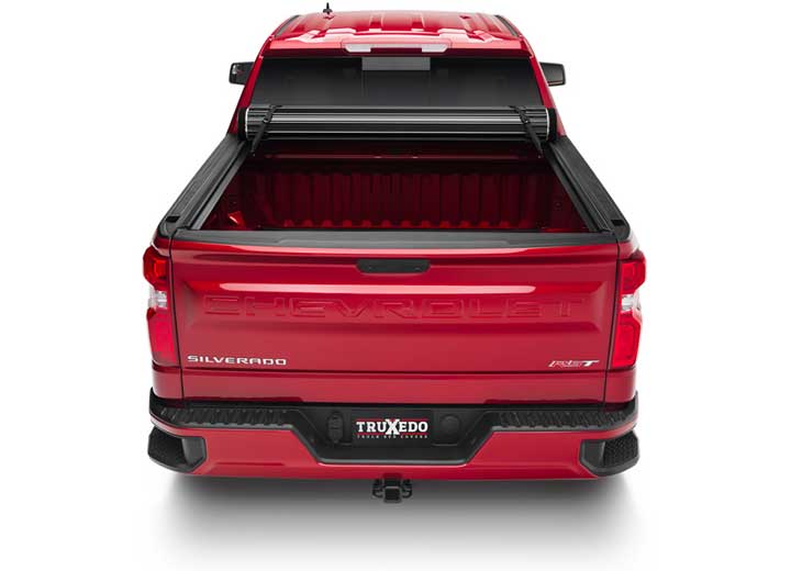 TruXedo Sentry hard roll-up tonneau cover rolled forward to the cab on a 2019-2024 Chevrolet Silverado 1500, straight rear view