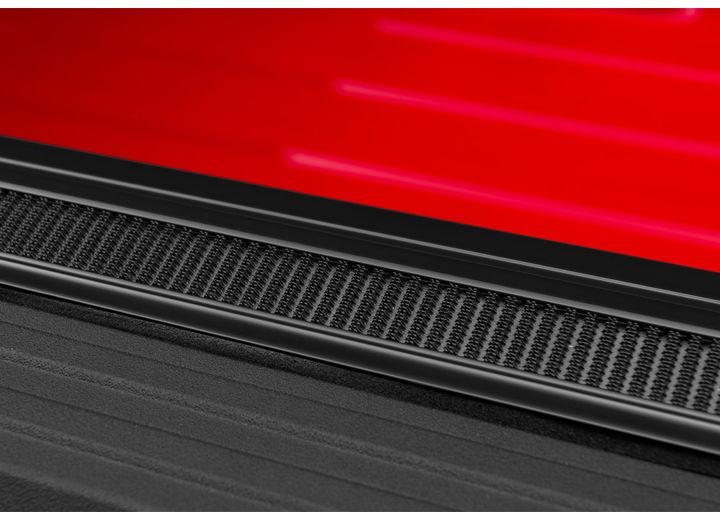 Close-up of the hook-and-loop fastening along the side rail on a TruXedo Sentry hard roll-up tonneau cover
