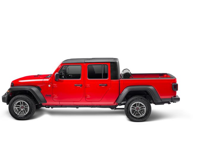 TruXedo Sentry hard roll-up tonneau cover rolled forward to the cab over the bed of a pickup truck, side profile