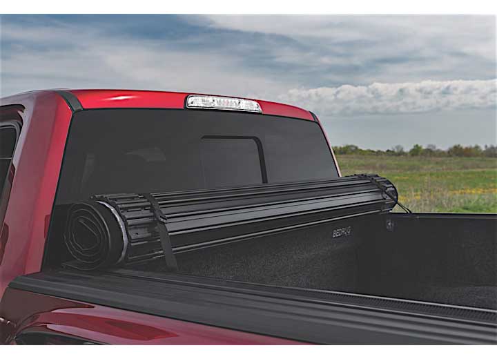 TruXedo Sentry hard roll-up tonneau cover rolled forward to the cab over the bed of a pickup truck, photographed on location